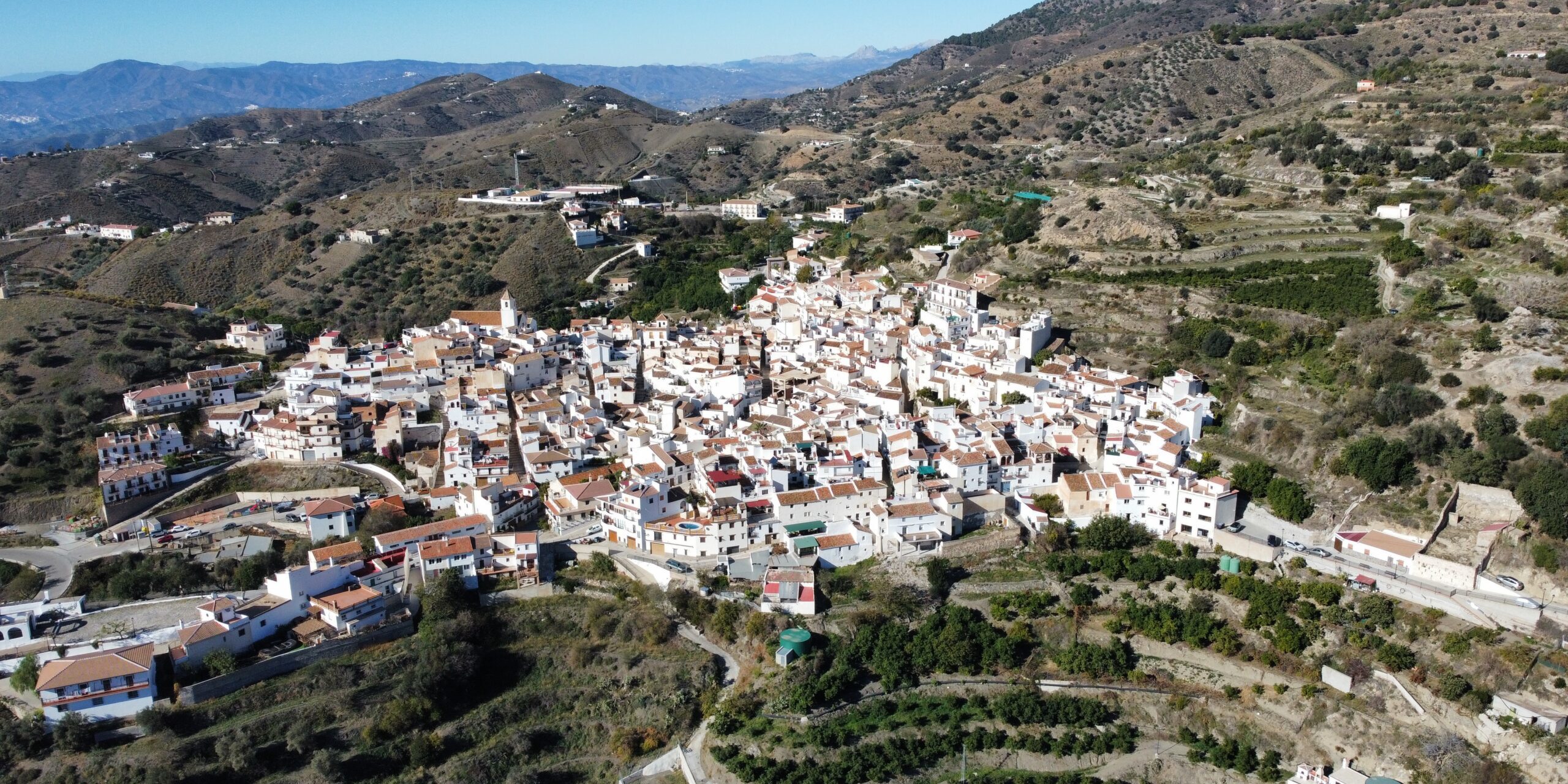 Vista aérea cautivadora de Sedella, un tesoro escondido entre montañas y valles. Disfruta de la serenidad de este pintoresco pueblo enclavado en la naturaleza.