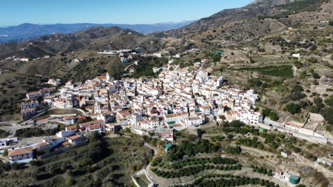Vista aérea cautivadora de Sedella, un tesoro escondido entre montañas y valles. Disfruta de la serenidad de este pintoresco pueblo enclavado en la naturaleza.